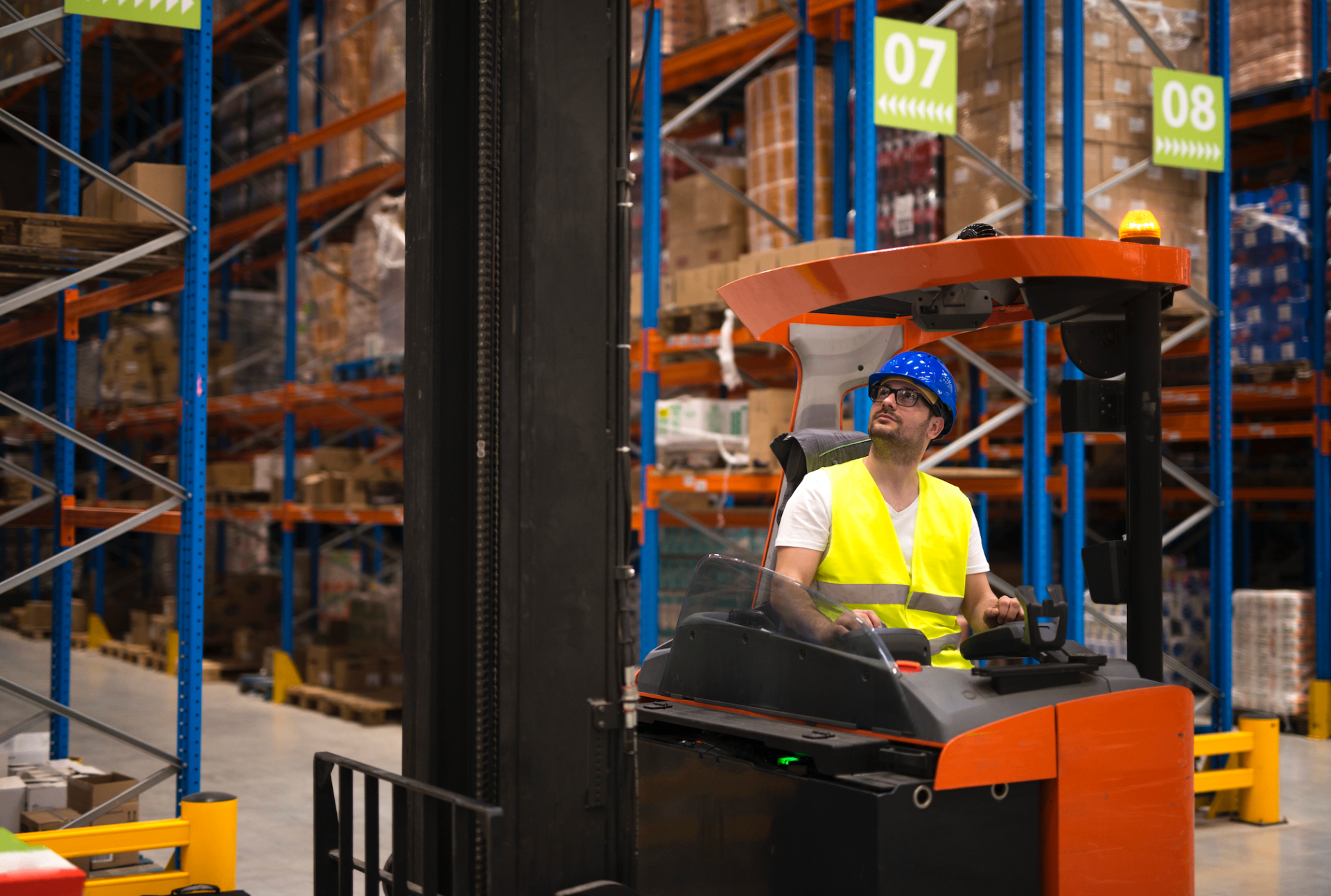 Forklift operator working in a modern warehouse